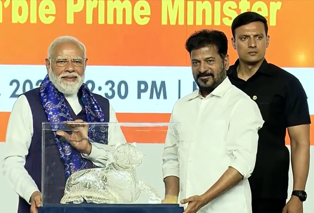 Prime Minister Narendra Modi receives a memento from Telangana Chief Minister A. Revanth Reddy at the programme in Hyderabad on Sunday.